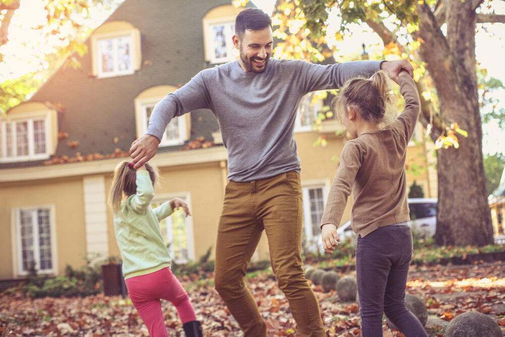 father playing with children