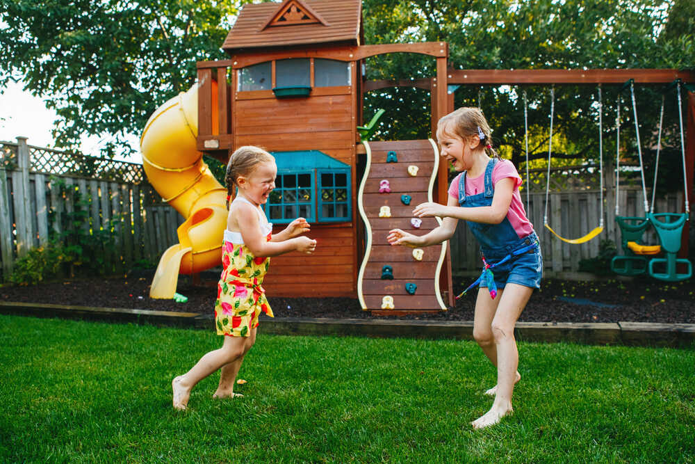 children playing in front of playset